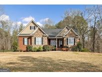Charming brick and stone home with well-maintained landscaping and a welcoming front entrance at 172 Sam Solomon Rd, Locust Grove, GA 30248