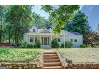 Charming single-Gathering home featuring a landscaped front yard and inviting covered porch at 3127 Mill Se St, Covington, GA 30014