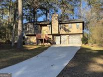 Charming two-story home with a two-car garage and well-manicured lawn at 2930 David Ne Ln, Conyers, GA 30012