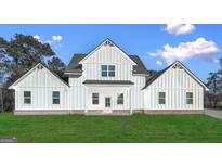 Stunning new construction features modern farmhouse design and a well-manicured lawn at 1081 E Lake Road, Mcdonough, GA 30252