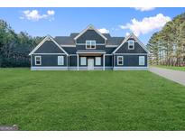 Beautiful new construction with a sprawling green lawn and a modern, farmhouse-style design at 2291 Airline Road, Mcdonough, GA 30252