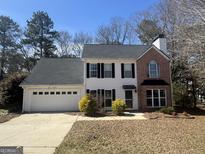 Charming two-story home with attached garage and well-maintained landscaping at 103 Vintage Trl, Mcdonough, GA 30253