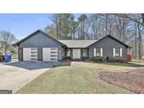 Charming single story home with a two-car garage and double front doors at 203 Hedgewood Ct, Peachtree City, GA 30269