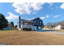 Charming blue two-story home with a cozy front porch and a well-maintained yard at 170 Cobblestone Ct, Douglasville, GA 30134