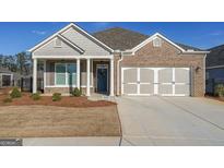 Charming brick and siding home with a two-car garage and inviting front porch at 171 Echols Bnd, Hiram, GA 30141