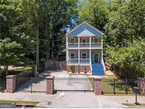 Two story home with a fenced front yard and double balconies at 1103 Coleman Sw St, Atlanta, GA 30310