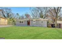 Charming single-story home with a well-manicured front lawn at 2690 Rollingwood Se Ln, Atlanta, GA 30316