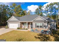 Charming single-Gathering home featuring stone accents, a two-car garage, and a welcoming front porch at 460 Carrie Kathleen Ter, Carrollton, GA 30116