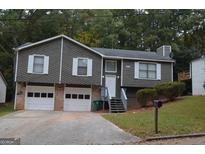 Charming home featuring a two-car garage and well-maintained front yard at 5475 Pepperwood Ct, Stone Mountain, GA 30087