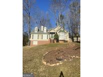 Charming single-Gathering home featuring a well-maintained lawn, neutral paint, brick foundation, and lush surrounding trees at 6906 Bell Ct, Rex, GA 30273