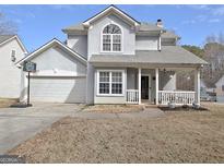Charming two-story home with covered front porch and attached two-car garage at 747 S Fairfield Dr, Peachtree City, GA 30269