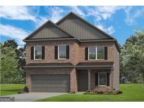 Charming two-story brick home with a two-car garage and classic architectural details at 10459 Trellis Lane (Lot 27), Hampton, GA 30228