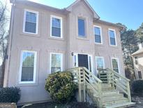 Two-story stucco home featuring a new wooden staircase and black front door at 3497 Thornewoode Pointe, Decatur, GA 30034