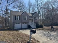 Charming gray two-story home with a two-car garage and a well-manicured front yard at 159 Aztec Se Way, Acworth, GA 30102