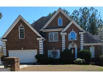 Charming two-story brick home featuring manicured landscaping and a classic architectural design at 2895 Battlecrest Dr, Decatur, GA 30034
