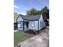 Charming single Gathering home with a blue front door and well manicured front lawn at 1066 Ashby Sw Grv, Atlanta, GA 30314