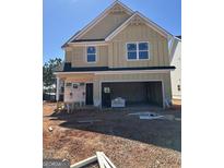 New construction two-story home with attached two-car garage and unfinished yard at 11192 Cornerstone Way, Hampton, GA 30228