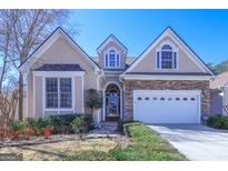 Charming home featuring stone accents, a two-car garage, and well-maintained landscaping at 168 Maple Grove Ter, Peachtree City, GA 30269