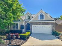 Attractive single-Gathering home featuring stone accents, well-kept landscaping, and a two-car garage at 168 Maple Grove Ter, Peachtree City, GA 30269