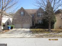 Charming brick home with a two-car garage and well-maintained lawn at 4286 Rosehall Ct, South Fulton, GA 30349