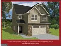 Charming two-story home with stone accents, a black roof, and an attached two-car garage at 11196 Cornerstone Way, Hampton, GA 30228