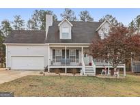 Charming home with a covered front porch, two-car garage, and appealing exterior at 1144 Pickets Ridge Dr, Locust Grove, GA 30248
