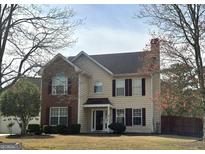 Charming two-story home featuring brick accents, symmetrical windows, and a well-maintained front yard at 912 Shadow Ridge Cir, Stockbridge, GA 30281