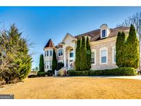 Elegant brick home boasts manicured lawn, lush landscaping, and stately architectural details at 1214 Greenridge Ln, Lithonia, GA 30058