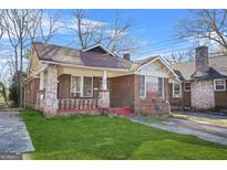 Charming brick home with a well-maintained lawn and traditional architectural details at 732 Cascade Sw Ave, Atlanta, GA 30310