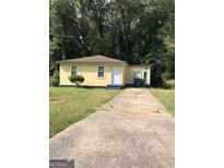 Charming single-story home with a well-maintained lawn and a private driveway at 3720 Asbury Sw Ln, Atlanta, GA 30331