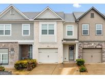 Charming townhome with a brick facade, attached garage, and well-maintained landscaping at 2271 Rolling Trl, Lithonia, GA 30058