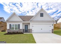 Charming single-Gathering home featuring a two-car garage, gray accents, and a well-maintained lawn at 423 Prescott Way, Villa Rica, GA 30180