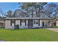 Charming single-story home with fresh, white paint, black trim, and a well-manicured front lawn at 3047 Horse Shoe Se Dr, Atlanta, GA 30316