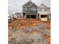 New construction townhomes feature an attached garage and modern architectural design at 44 Leggit Dr # 179, Villa Rica, GA 30180