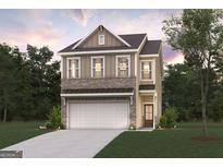 Charming two-story home featuring a brick-and-siding facade, attached garage, and a well-manicured front lawn at 988 Sutherland Lane # 33, Lawrenceville, GA 30043