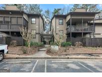 Charming townhouse with a brown facade, well-maintained landscaping, and convenient parking at 510 River Run Dr, Atlanta, GA 30350