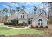 Charming two-story home with inviting front yard landscaping and a classic architectural style at 238 Harvest Trce, Sharpsburg, GA 30277