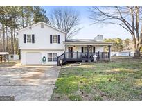 Charming two-story home with a welcoming front porch and attached garage at 916 Marshall Fuller Rd, Dallas, GA 30157