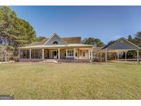 Charming single-story home with a large, inviting porch and carport at 318 Turner Cir, Mcdonough, GA 30252