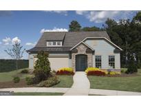 Charming exterior of a single-Gathering home with manicured lawn, stone accents, and welcoming front entrance at 2446 Naples St, Hoschton, GA 30548