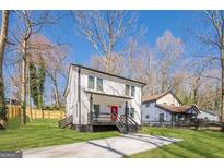 Charming two-story home with landscaped yard, black accents, and bright red front door at 200 Adeline Nw Ave, Atlanta, GA 30314