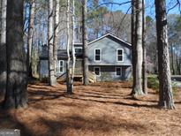 Traditional two-story home featuring a classic exterior with gray siding and a welcoming front porch at 1967 Levgard Ln, Riverdale, GA 30296