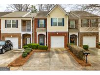 Charming townhomes with brick and siding exteriors, well-manicured lawns, and private driveways at 2786 Snapfinger Mnr, Decatur, GA 30035