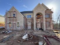 A new two-story brick home featuring an arched entryway is currently under construction, showcasing its classic design at 6600 Wansfell Ct # 28, Douglasville, GA 30135