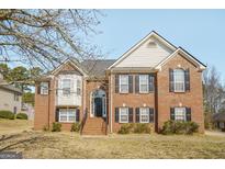 Charming two-story brick home featuring black shutters and a well-manicured front yard at 1421 Saint Charles Ct, Conyers, GA 30094