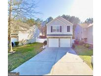 Charming two-story home features a well-manicured lawn and a two-car garage at 3466 Carriage Chase Rd, Atlanta, GA 30349