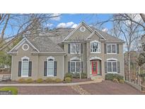 Charming two-story home featuring stucco and a symmetrical facade with a bright red front door at 804 Carnellian Ln, Peachtree City, GA 30269