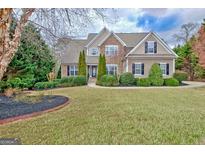 Charming two-story home with stone accents, well-manicured landscaping and inviting curb appeal at 135 Edgewater Trl, Fayetteville, GA 30215