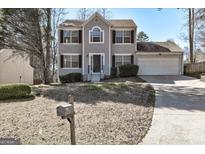 Charming two-story home with a well-manicured front yard and attached two-car garage, offering great curb appeal at 2561 Rainover Ct, Decatur, GA 30034