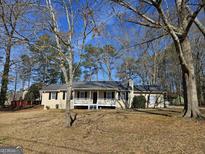 Charming ranch-style home with a cozy front porch and well-maintained lawn, perfect for suburban living at 245 Kim Trl, Stockbridge, GA 30281